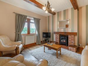 a living room with a couch and a fireplace at Highfield Cottage in Hambleton