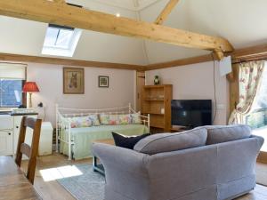 a living room with a couch and a bed at The Granary in West Hoathley