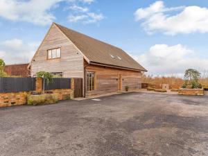 a large wooden barn with a parking lot at Olive Lodge in Melbourne