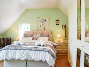 a bedroom with a large bed and green walls at The Old Exchange in Market Bosworth