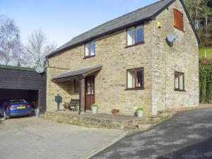 a brick house with a car parked in front of it at Border View in Kington