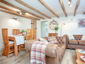 a living room with a couch and a table at Splash Cottage in Widecombe in the Moor