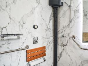 a bathroom with a marble shower with a bench at The Bothy in Kirktown of Auchterless