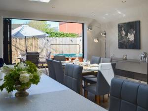 a dining room with a table and chairs and an umbrella at Regent Cottage in Beverley