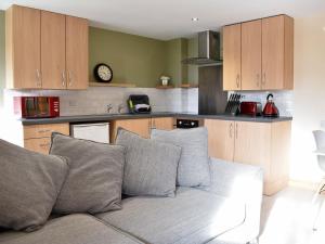 a living room with a couch in a kitchen at Sheep One - Uk33361 in Threlkeld