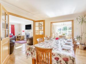 a dining room with a table and chairs at Lochside House - S4532 in Letterfearn