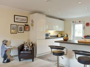 a kitchen with a couch and a chair in a room at Elizabeth House in Bampton