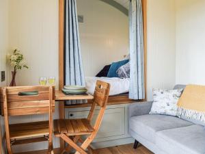 a room with a table and a chair and a mirror at Grace in Braunston