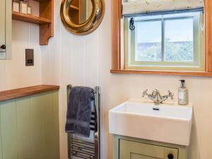 a bathroom with a sink and a window at Grace in Braunston