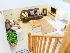 a living room with a couch and a coffee table at Ty Arth - Uk31652 in New Quay