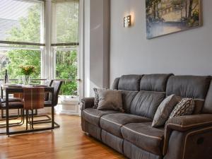 a living room with a couch and a table at Church View Apartment in Scarborough