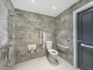 a bathroom with a toilet and a shower at The Barn Owl - Uk36217 in Bowness-on-Solway