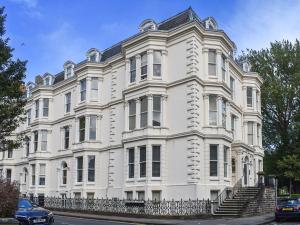 a large white building with stairs in front of it at Church View Apartment in Scarborough