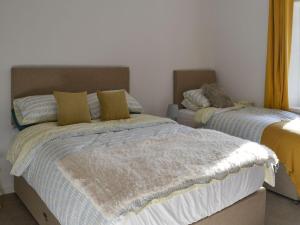 En eller flere senge i et værelse på Horsley Cottage