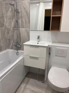 a bathroom with a toilet and a sink and a shower at Kärberi Apartments in Tallinn