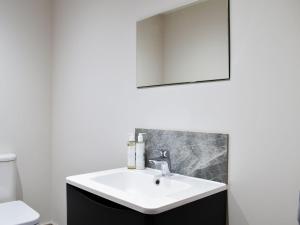 uma casa de banho com um lavatório branco e um espelho. em The Old Stables 2 - Uk35616 em West Winterslow