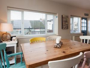 a dining room with a wooden table and chairs at Aloft in Salcombe