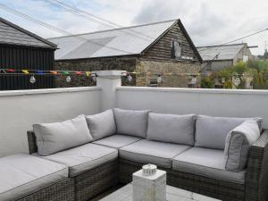 a couch sitting on top of a balcony at Aloft in Salcombe