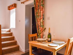 a dining room with a table and a bottle of wine at Swallows Folly-uk38278 in Cloughton