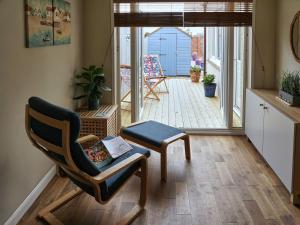 a living room with a chair and a porch at Haven View in Berwick-Upon-Tweed