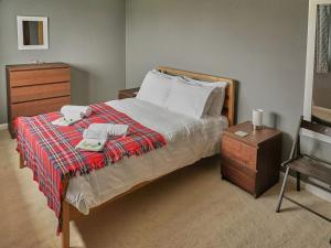 a bedroom with a bed with two towels and a dresser at Haven View in Berwick-Upon-Tweed