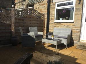 a group of chairs and a table on a patio at Nidd Cottage in Pateley Bridge