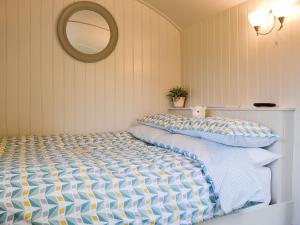 a bedroom with a large bed with a mirror at Skiddaw - Uk1354 in Applethwaite