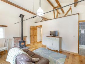 a living room with a couch and a fireplace at The Croft in Laneham