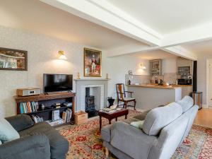 a living room with two couches and a fireplace at Little Crown in Winfarthing