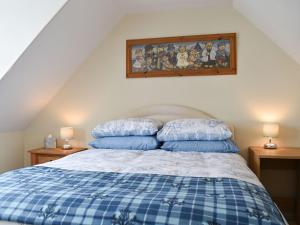a bedroom with a bed with two pillows on it at Tradewinds in Portknockie