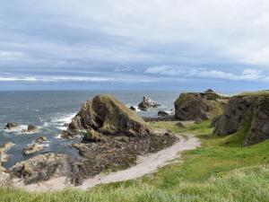 a rocky beach with rocks in the ocean at Tradewinds in Portknockie