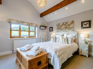 a bedroom with a large bed and a window at The Old Barn in Cloughton
