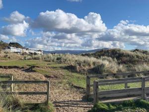 a wooden bench sitting on top of a hill at Driftwood in Aberdyfi