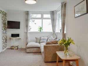 a living room with a couch and a window at Cotters Cottage - Uk10922 in Whithorn