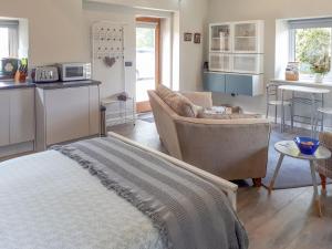 a living room with a couch and a kitchen at The Studio At Westfield in Bellingham