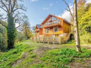 a large wooden house in the middle of a field at Waterside Lodge One - Uk33351 in Southowram