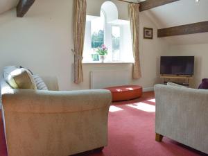 a living room with two chairs and a flat screen tv at One Uk33732 in Cartworth