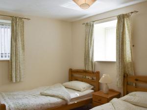 a bedroom with two twin beds and a window at One Uk33732 in Cartworth
