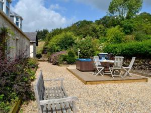 a patio with a table and chairs and a table and chairs at The Brewers Cottage in Mauchline