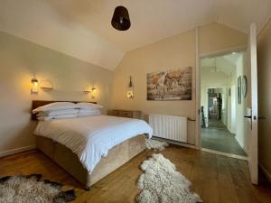 a bedroom with a large bed and a walk in shower at Sheenas Butnben in Arnisdale