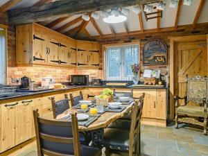 a kitchen with a table and chairs in a kitchen at Honey Pots in Foulden