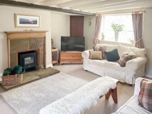 a living room with a couch and a fireplace at Seacrest Cottage in Whitby