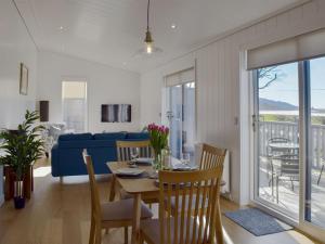 a dining room and living room with a table and chairs at Cree Lodge - Uk13636 in Creetown