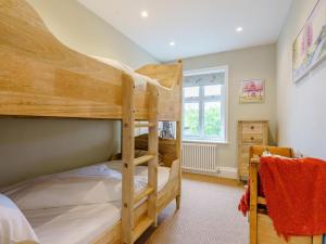 a bedroom with two bunk beds and a window at Inner Lodge in Bolton by Bowland