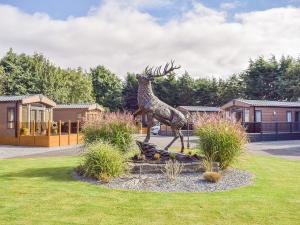 a statue of a deer statue in a yard at Riverside Lodge in Auchterarder