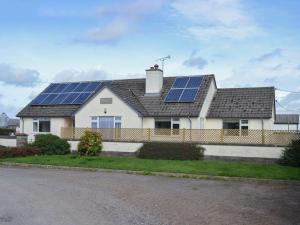 a house with solar panels on the roof at The Old Creamery in Witheridge