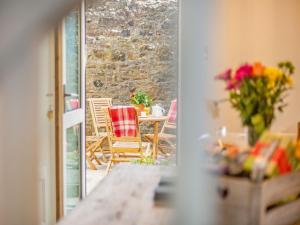 a balcony with a table and chairs on a patio at Hillside Cottage in Haltwhistle
