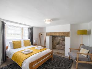 a bedroom with a large bed and a fireplace at Edenholme in Robin Hood's Bay