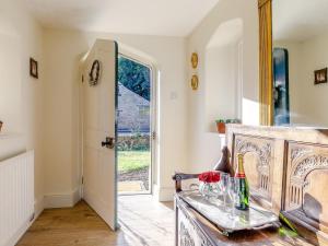 a dining room with a glass table and a door at Gardeners Cottage - Uk35774 in Fulbeck