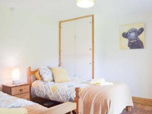 a living room with a bed and a mirror at Typicca Farmhouse in Brechfa